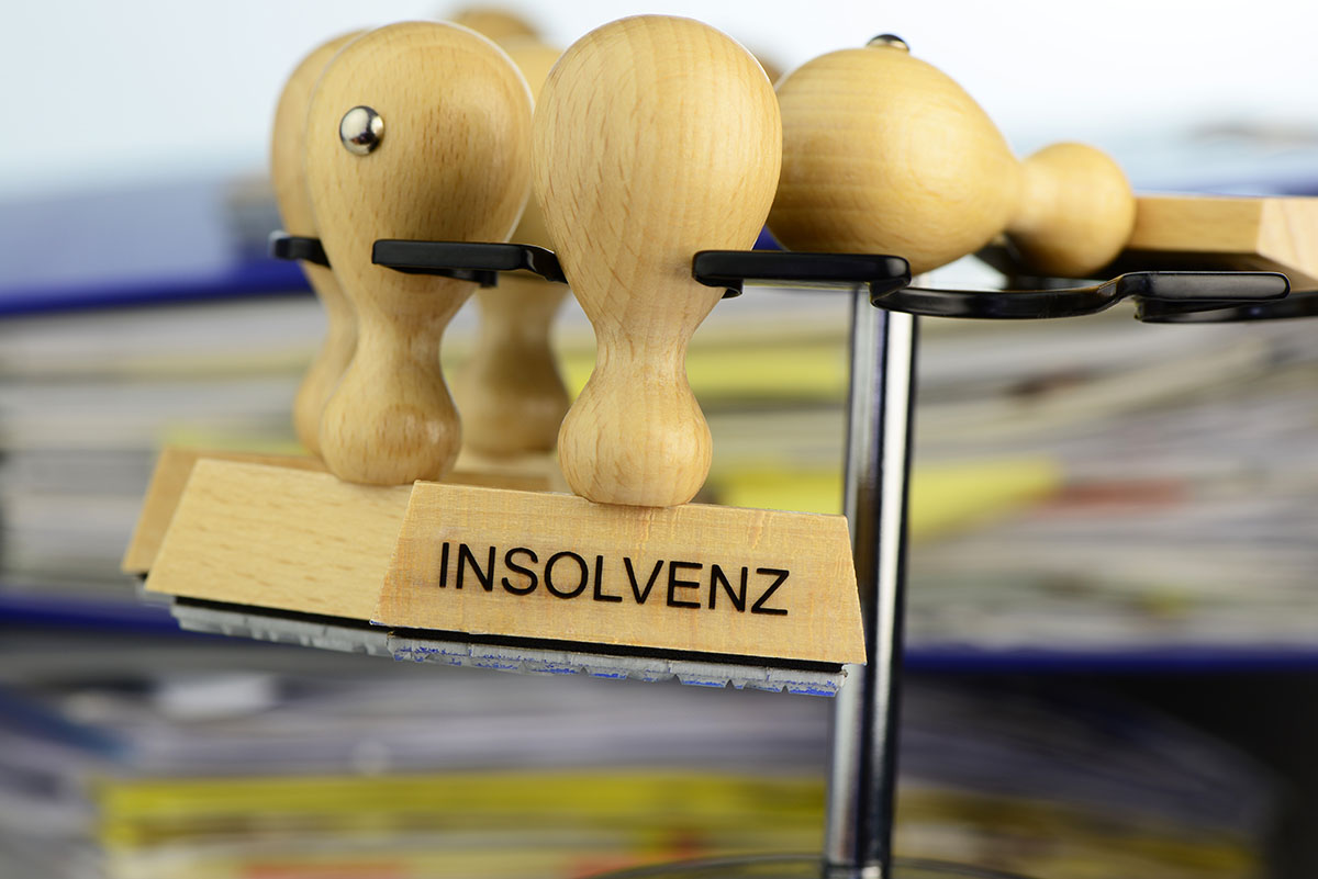 Stempel mit der Aufschrift Insolvenz als Symbol für Insolvenzstraftaten und Krisenszenarien
